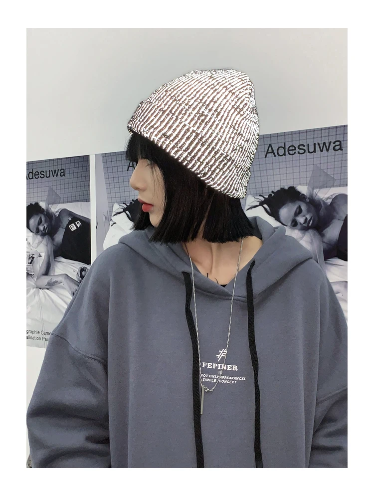 Reflective beanie showing reflective strip lit up in low light
