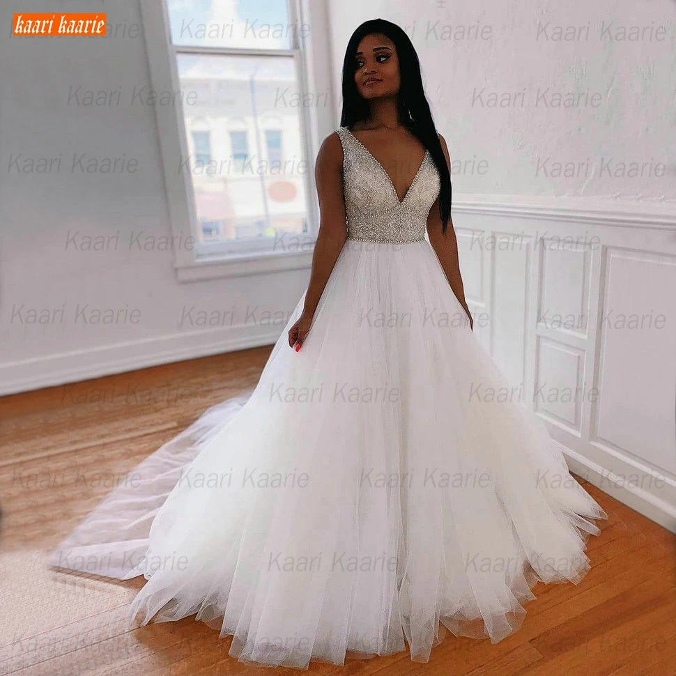 Africa Beaded Wedding Gowns V Neck Crystal abito da sposa Sleeveless Tulle Ball Gown Bride Dresses 2021 Customized suknie slubne 
Africa Beaded Wedding Gowns V Neck Crystal abito da sposa Sleeveless Tulle Ball Gown Bride Dresses 2021 Customized suknie slubne