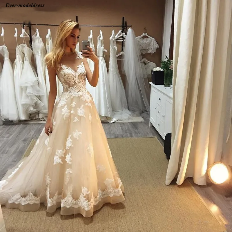 Elegant Champagne Tulle 2019 Wedding Dresses Lace Appliques Sheer Neck Cap Sleeves A-Line Garden Bride Dresses robe de mariee
Elegant Champagne Tulle 2019 Wedding Dresses Lace Appliques Sheer Neck Cap Sleeves A-Line Garden Bride Dresses robe de mariee