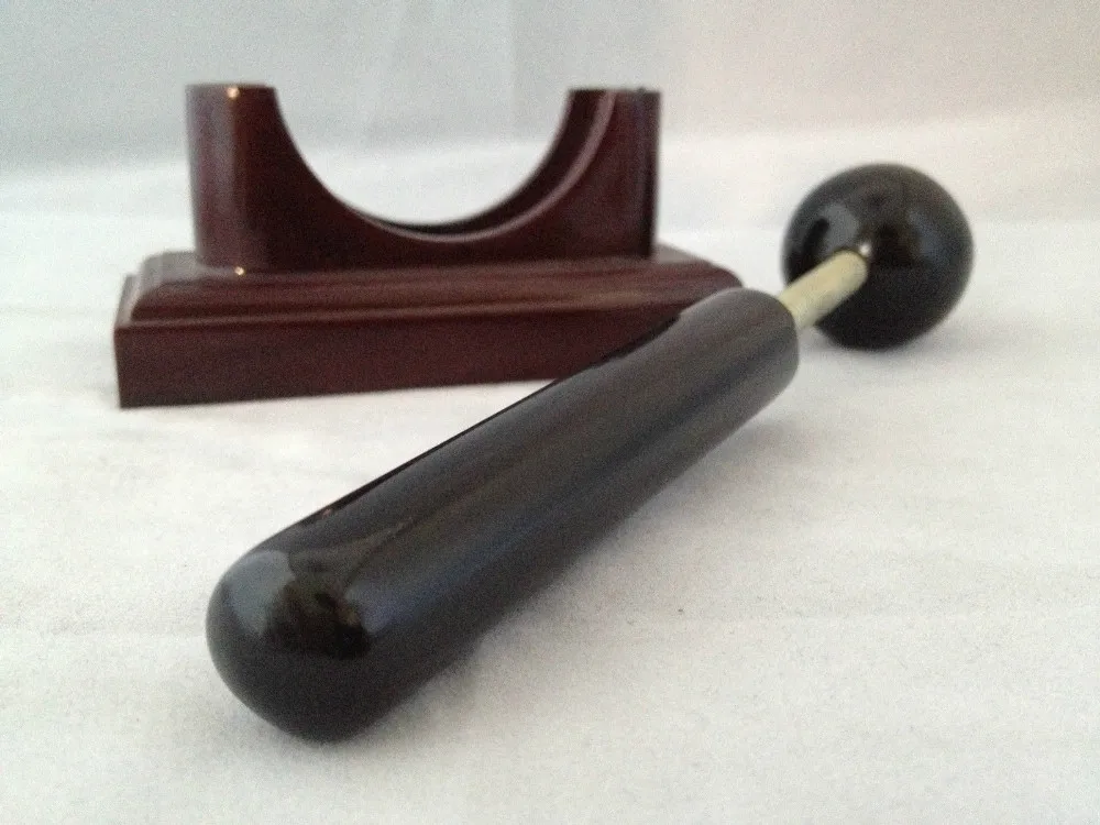 Massage therapy Sphere Black Jade Stone Hammer Tool in front of its base