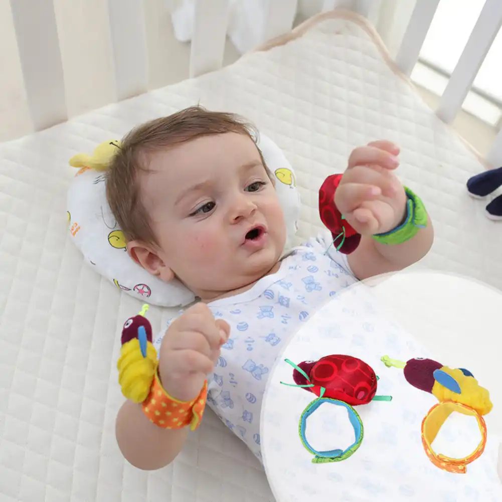 baby playing with rattle