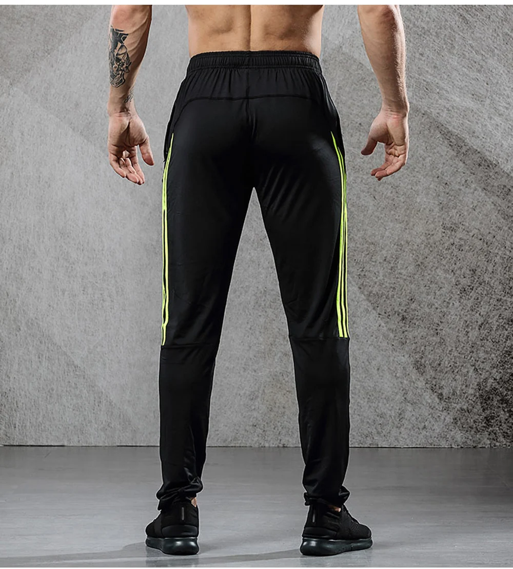 Image from the back men's breathable elastics pants for sport. Sport's breathable leggings for sport black with yellow line color. Foto from the back men's breathable elastics pants for sport. Sport's breathable leggings for sport black with yellow line color.