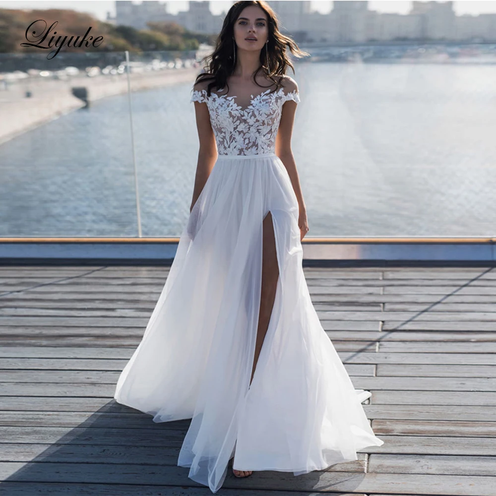 Liyuke Simple Off-White Color Beach Wedding Dress With Side Cut Scalloped Neckline Puffy Skirt Wedding Gown
Liyuke Simple Off-White Color Beach Wedding Dress With Side Cut Scalloped Neckline Puffy Skirt Wedding Gown