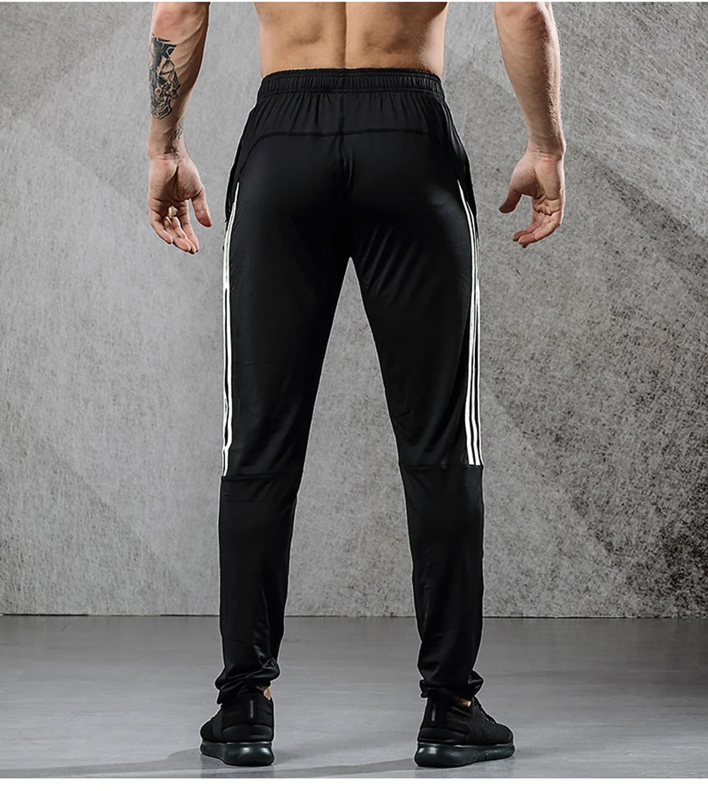 Image from the back men's breathable elastics pants for sport. Sport's breathable leggings for sport black with white line color. Foto from the back men's breathable elastics pants for sport. Sport's breathable leggings for sport black with white line color.
