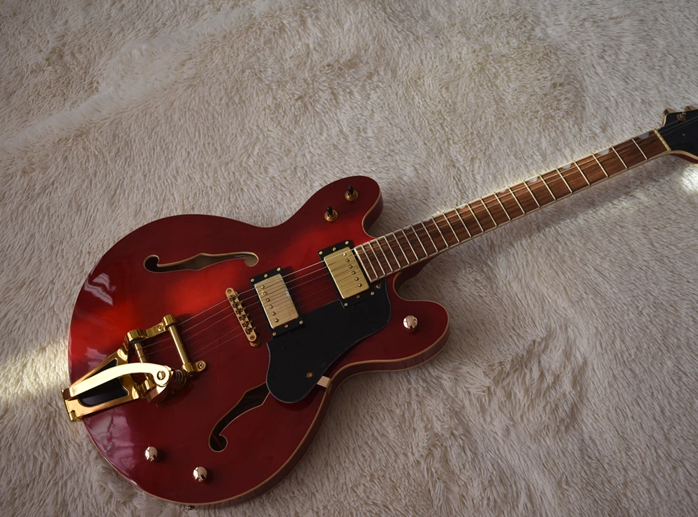 Factory custom semi-hollow red electric guitar with vibrato system, gold hardware, cream binding body and neck, can be customize
Factory custom semi-hollow red electric guitar with vibrato system, gold hardware, cream binding body and neck, can be customize