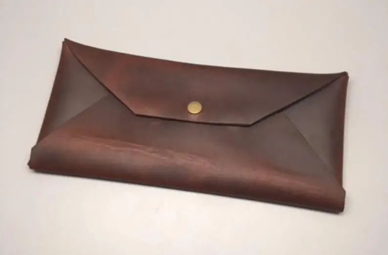 Handmade full grain leather envelope made with heavy duty snaps It measures 4.5" high by 9.75 inches wide when shut
Handmade full grain leather envelope made with heavy duty snaps It measures 4.5" high by 9.75 inches wide when shut