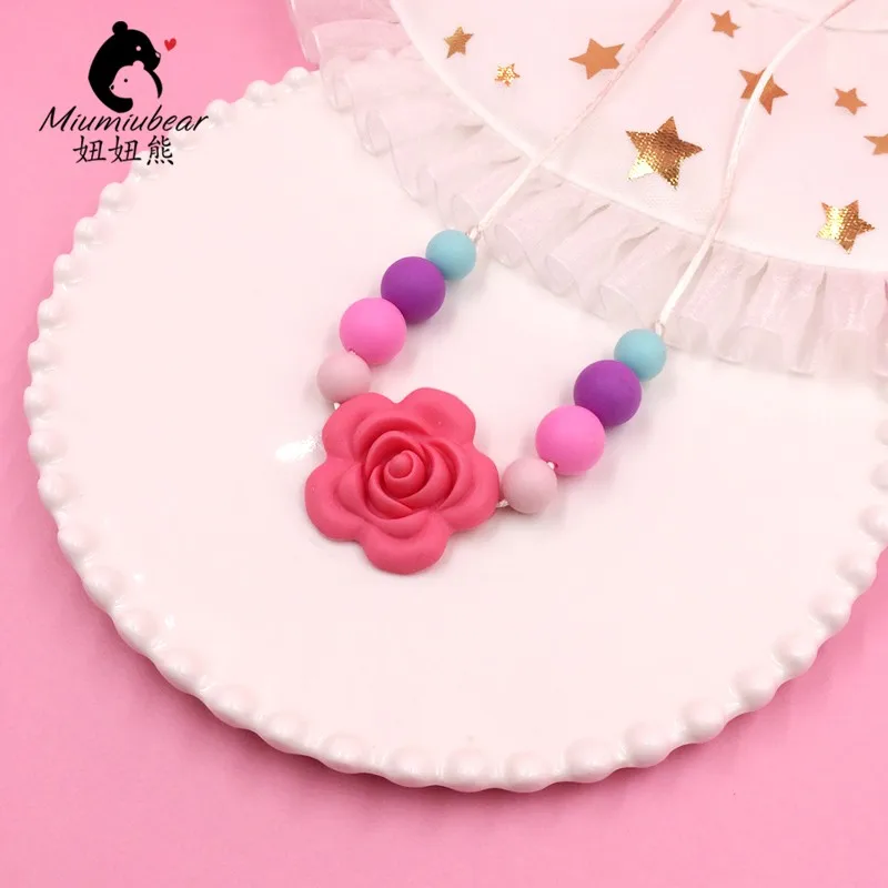 Baby silicone teether necklace chewable rainbow beads with star flower baby wearing FDA approved
Baby silicone teether necklace chewable rainbow beads with star flower baby wearing FDA approved