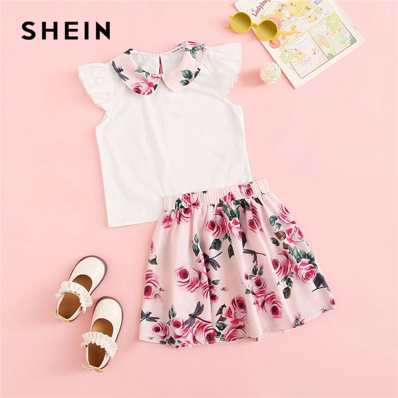 SHEIN Kiddie Peter Pan Collar Blouse And Floral Print Skirt Girls Suit Set 2019 Summer Cap Sleeve Button Back Kids Cute Outfits
SHEIN Kiddie Peter Pan Collar Blouse And Floral Print Skirt Girls Suit Set 2019 Summer Cap Sleeve Button Back Kids Cute Outfits