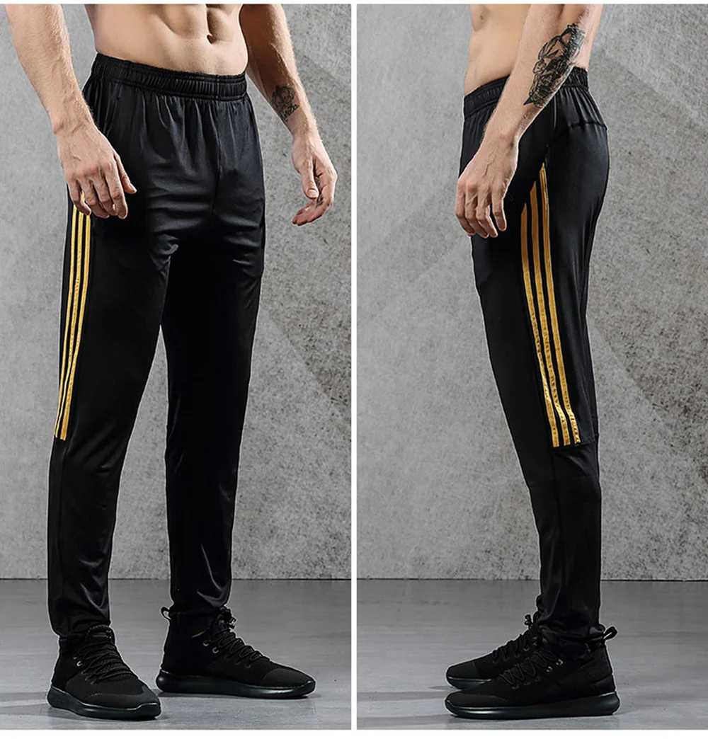 Image from the right and the down men's breathable elastics pants for sport. Sport's breathable leggings for sport black with orange line color. Foto from the right and the down men's breathable elastics pants for sport. Sport's breathable leggings for sport black with orange line color.
