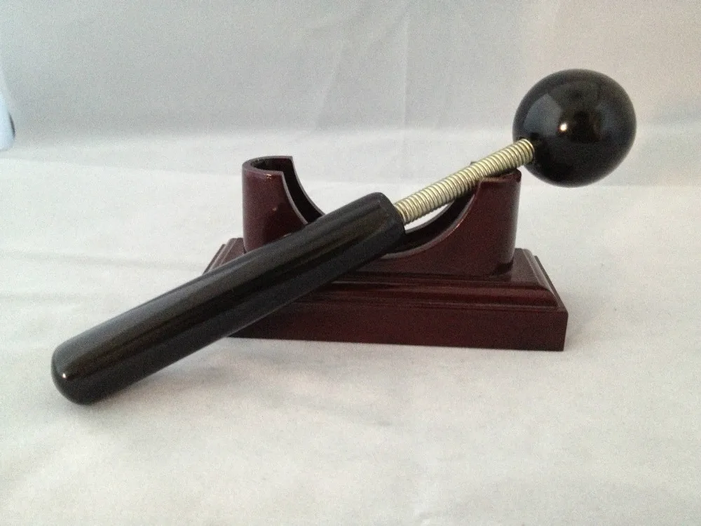 Massage therapy Sphere Black Jade Stone Hammer Tool leaning on its base