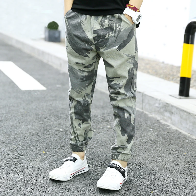 The boy wore thin summer camouflage trousers with loose summer mosquito repellent trousers 
The boy wore thin summer camouflage trousers with loose summer mosquito repellent trousers