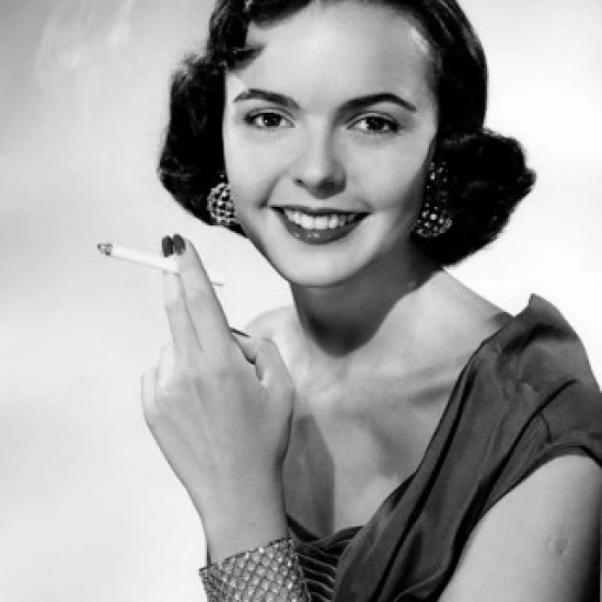 Studio portrait of smiling young woman with cigarette Poster Print (18 x 24)