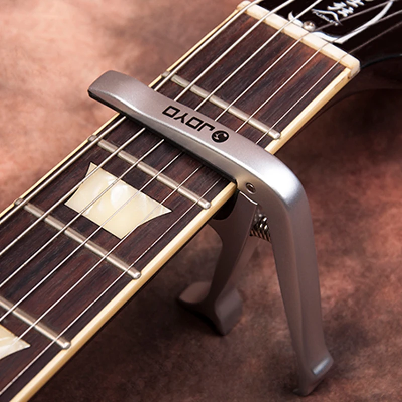JOYO JCP-02 Alloy Capo Multifunction for Acoustic Electric Guitar Bottle Opener musical instruments guitarras Bridge Pins Puller 
JOYO JCP-02 Alloy Capo Multifunction for Acoustic Electric Guitar Bottle Opener musical instruments guitarras Bridge Pins Puller