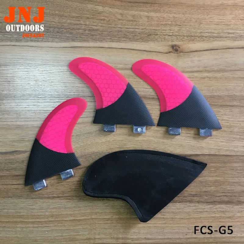 FCS base G5 M size surfboard fins surfing thrusters made of carbon and pink fiberglass
FCS base G5 M size surfboard fins surfing thrusters made of carbon and pink fiberglass