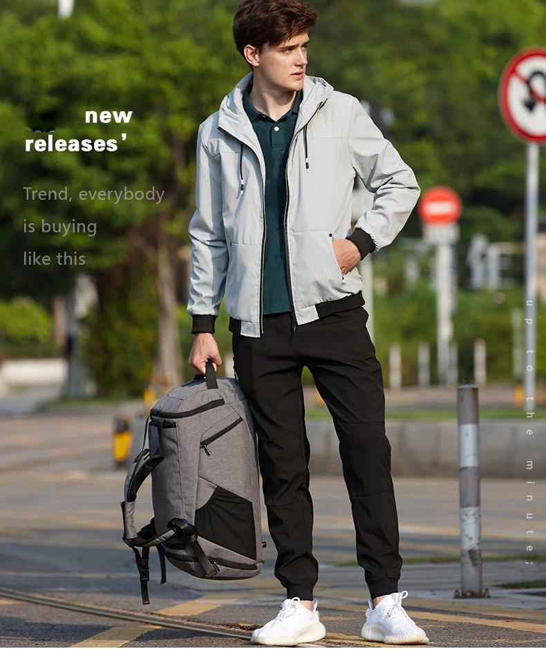 a guy holding a duffle on the street