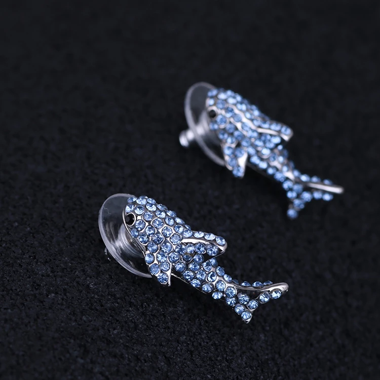 American designer's quirky personality sparkles with water and blue delicate sharks and fashionable earrings
American designer's quirky personality sparkles with water and blue delicate sharks and fashionable earrings