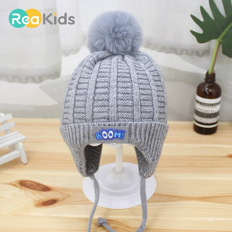 

REAKIDS Cute Children Pompon Hat For Baby Winter Knitted Girls Boys Hat Cotton Earmuffs Baby Pompon Beanies Warm Hat Unisex