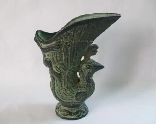 

Ancient Chinese bronze palace royal wine glasses. The frog. The peacock cup