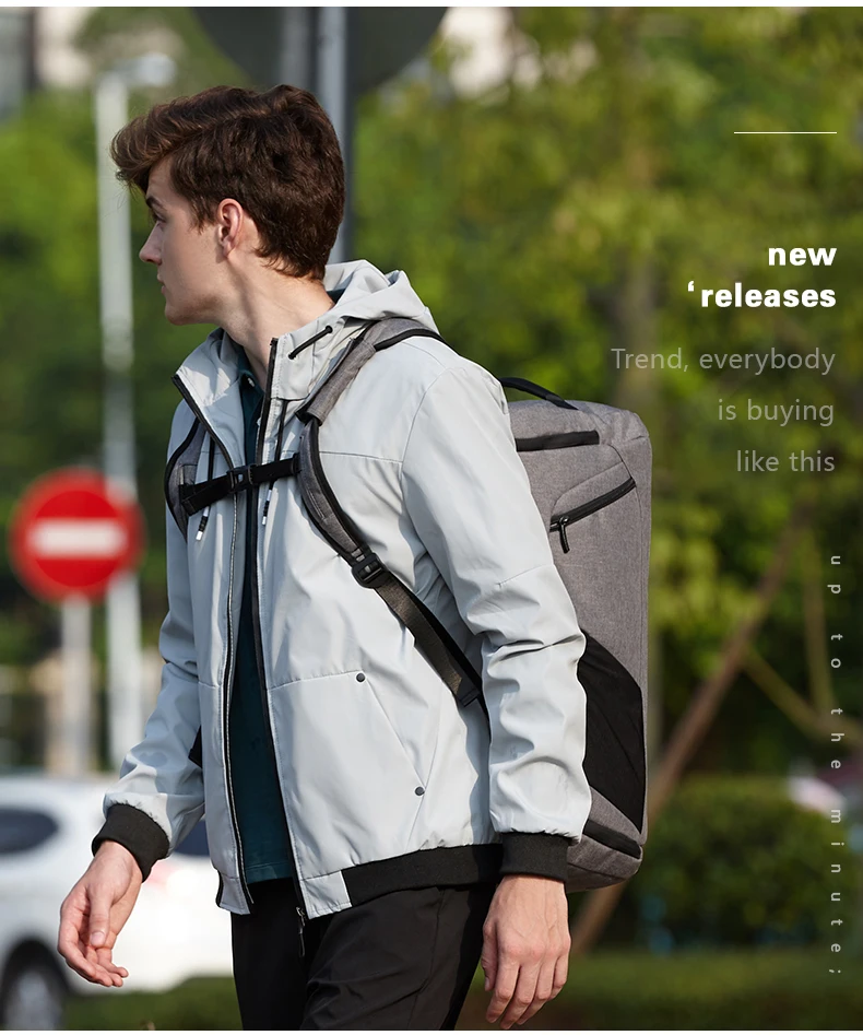 a guy carrying a grey backpack