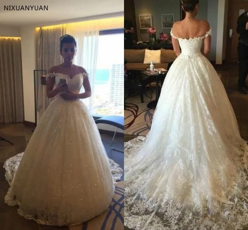 Lace Wedding Dresses 2019 Off Shoulder Sequins Appliques Chapel Train Wedding Gowns Covered Button Bohemian Wedding Bridal Gowns 
Lace Wedding Dresses 2019 Off Shoulder Sequins Appliques Chapel Train Wedding Gowns Covered Button Bohemian Wedding Bridal Gowns