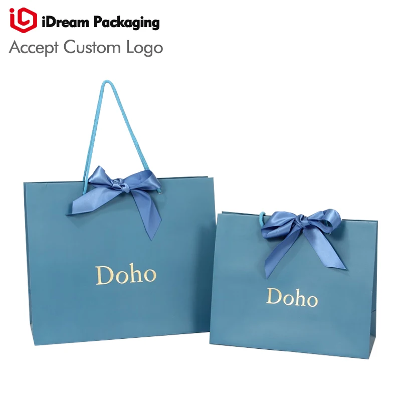 blue color Silver logo emboss paper bag with blue ribbon cosmetic Makeup sale shopping paper bag idream packaging
blue color Silver logo emboss paper bag with blue ribbon cosmetic Makeup sale shopping paper bag idream packaging