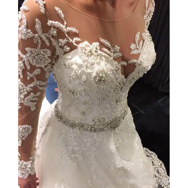 Newest Appliqued Lace Tulle Wedding Dresses 2019 Button Back Beaded Belt Long Sleeve Chapel Train Bride Dress
Newest Appliqued Lace Tulle Wedding Dresses 2019 Button Back Beaded Belt Long Sleeve Chapel Train Bride Dress