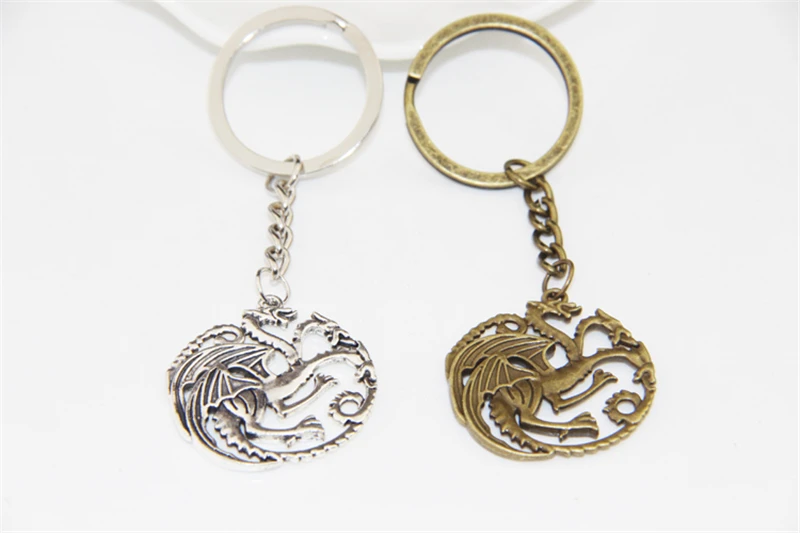 ZRM 20pcs/lot Fashion Jewelry Vintage Silver Bronze Charm Song Of Ice And Fire Game Of Thrones Targaryen Dragon Badge Keychain
ZRM 20pcs/lot Fashion Jewelry Vintage Silver Bronze Charm Song Of Ice And Fire Game Of Thrones Targaryen Dragon Badge Keychain