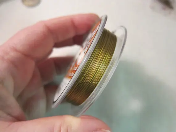 Accu-Flex, 7-Strand Beading Wire, 0.012" diameter, Nylon Coated Brass - Available in 30 foot & 100 foot Spools and in Multi-Pack
Accu-Flex, 7-Strand Beading Wire, 0.012" diameter, Nylon Coated Brass - Available in 30 foot & 100 foot Spools and in Multi-Pack