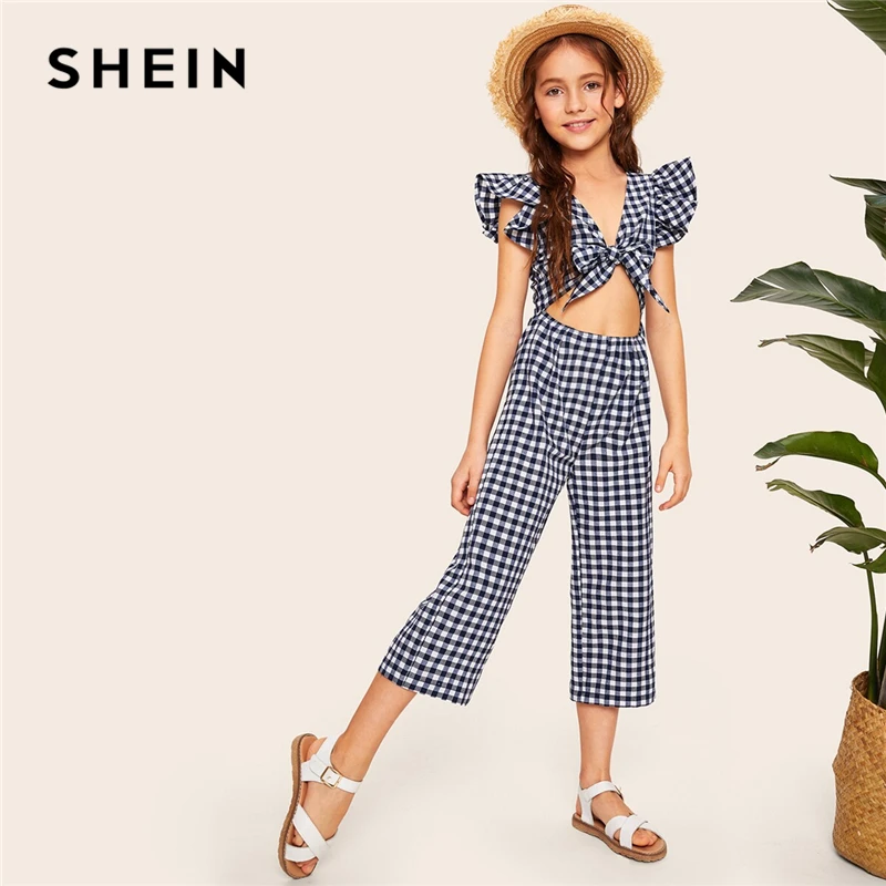 SHEIN Kiddie Girls V Neck Navy Gingham Ruffle Armhole Knot Cutout Front Jumpsuit 2019 Summer Cap Sleeve Boho Beach Jumpsuits
SHEIN Kiddie Girls V Neck Navy Gingham Ruffle Armhole Knot Cutout Front Jumpsuit 2019 Summer Cap Sleeve Boho Beach Jumpsuits