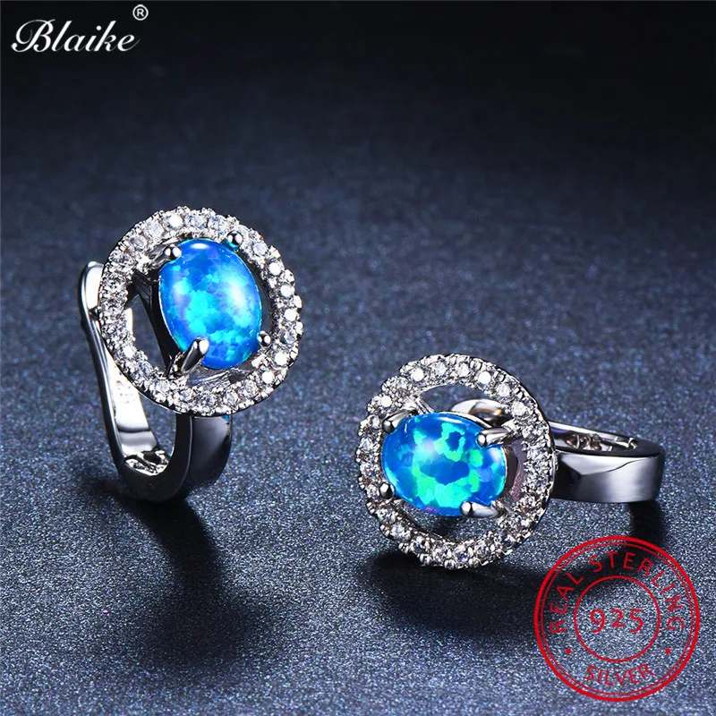 Женские серьги кольца из серебра 925 пробы с овальным камнем и голубым огненным