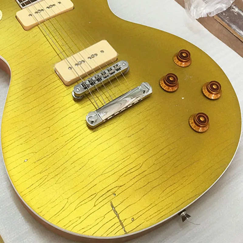 Factory direct selling gold powder used electric guitar P90 pickup retro old, hand carved electric guitar, hair pictures can bui
Factory direct selling gold powder used electric guitar P90 pickup retro old, hand carved electric guitar, hair pictures can bui