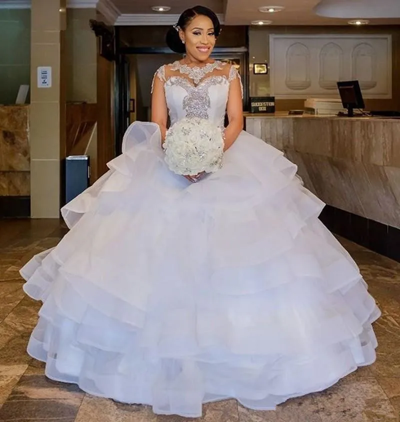Ball Gown Sparkly Crystal Wedding Dresses 2019 Ruffles Tiered Skirt Lace Jewel Cathedral Train Cap Sleeve African Wedding Gown
Ball Gown Sparkly Crystal Wedding Dresses 2019 Ruffles Tiered Skirt Lace Jewel Cathedral Train Cap Sleeve African Wedding Gown