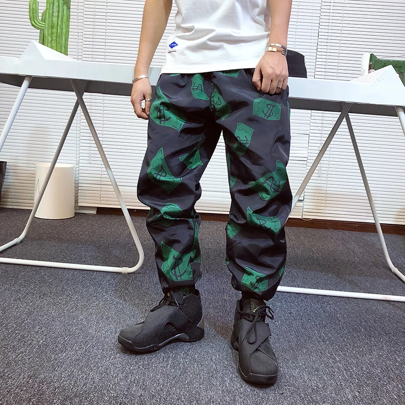 Autumn Streetwear Dollar Printing Harem Pants Men Draw String Elastic Waist Hip Hop Pants Leg Opening Zipper Male Trousers
Autumn Streetwear Dollar Printing Harem Pants Men Draw String Elastic Waist Hip Hop Pants Leg Opening Zipper Male Trousers