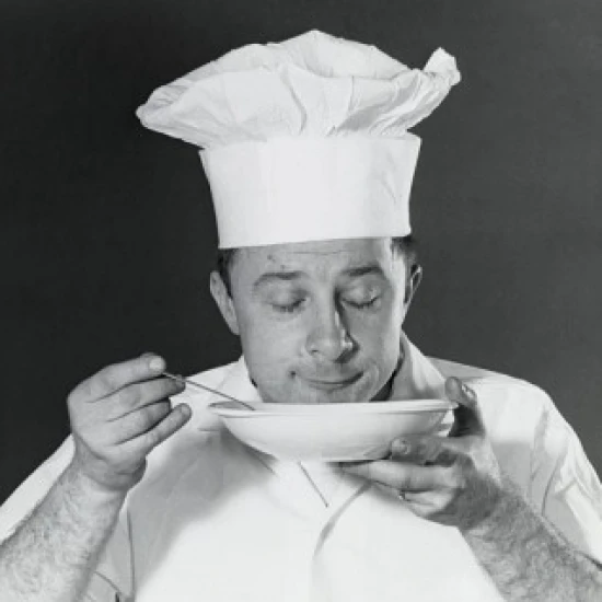 Close-up of a chef smelling a dish Poster Print (18 x 24)