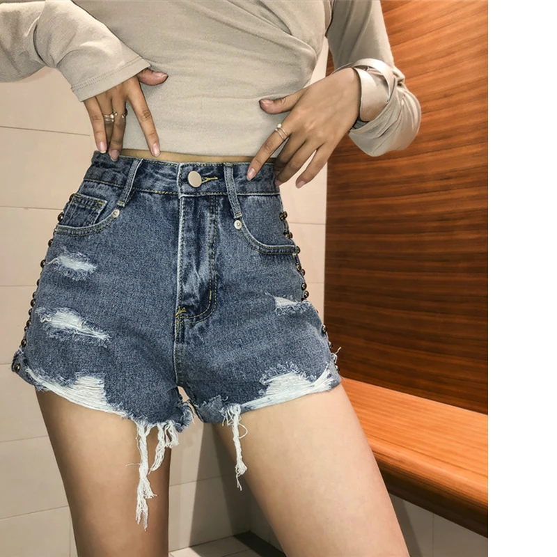 Шорты женские джинсовые с завышенной талией, пикантные винтажные Широкие штаны с бахромой и заклепками, в байкерском стиле, повседневные свободные пляжные штаны для девушек, Лидер продаж 
Шорты женские джинсовые с завышенной талией, пикантные винтажные Широкие штаны с бахромой и заклепками, в байкерском стиле, повседневные свободные пляжные штаны для девушек, Лидер продаж