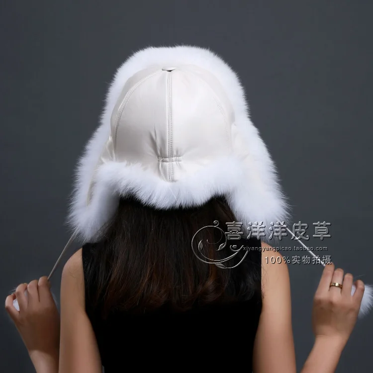 black leather hat with fur ball on top