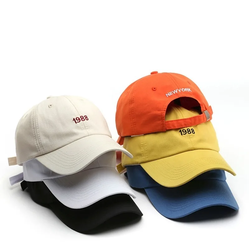 Unisex cotton cap alongside men's fashion items including jackets, suits, shorts, shoes, oversized watches, and hoodies in a streetwear style5