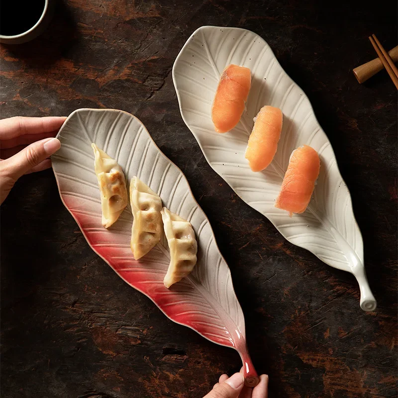 Japanese retro kiln leaves sushi plate commercial ceramic snack plate jiaozi sashimi long plate saury plate.
Japanese retro kiln leaves sushi plate commercial ceramic snack plate jiaozi sashimi long plate saury plate.