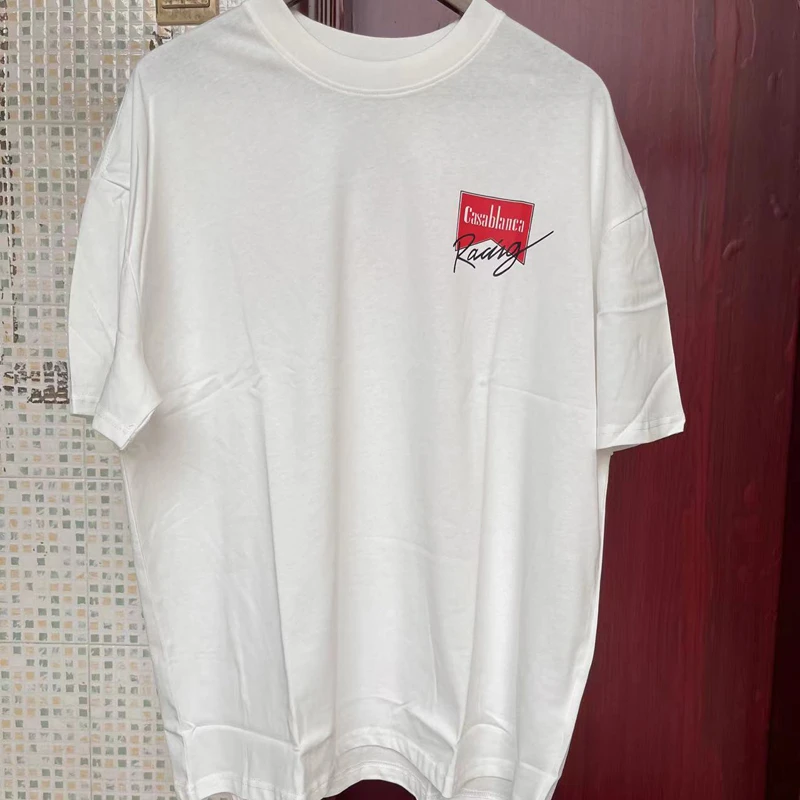 Real Photos CASABLANCA T-shirts Racing Signature Letter Print Short Sleeve 3XL Cotton Loose T Shirt for Men Women
Real Photos CASABLANCA T-shirts Racing Signature Letter Print Short Sleeve 3XL Cotton Loose T Shirt for Men Women