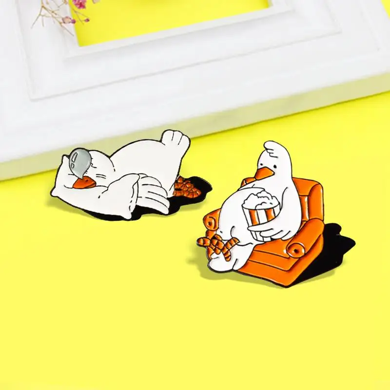 

Lovely Goose Enamel Pin Cute White goose Watch TV Eat Popcorn Sleep Brooches Funny Badge Lapel for Friends Jewelry Accessories