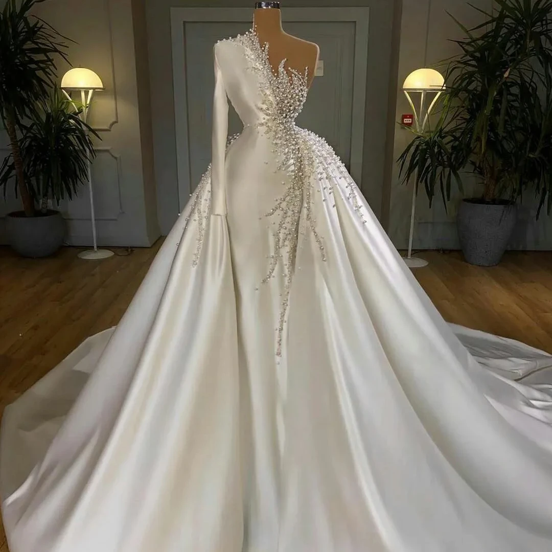 2024 New Luxury A-Line Wedding Dresses Pearls Beadings One Shoulder Satin Long Sleeves Overskirts Detachable Train Bridal Gowns
2024 New Luxury A-Line Wedding Dresses Pearls Beadings One Shoulder Satin Long Sleeves Overskirts Detachable Train Bridal Gowns