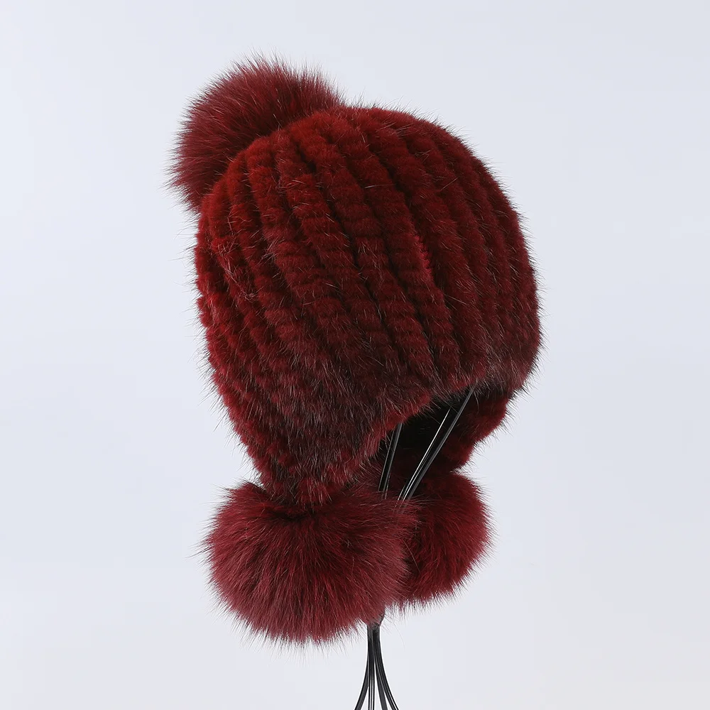 Women’s winter trapper hat made of genuine mink fur with fox pom pom