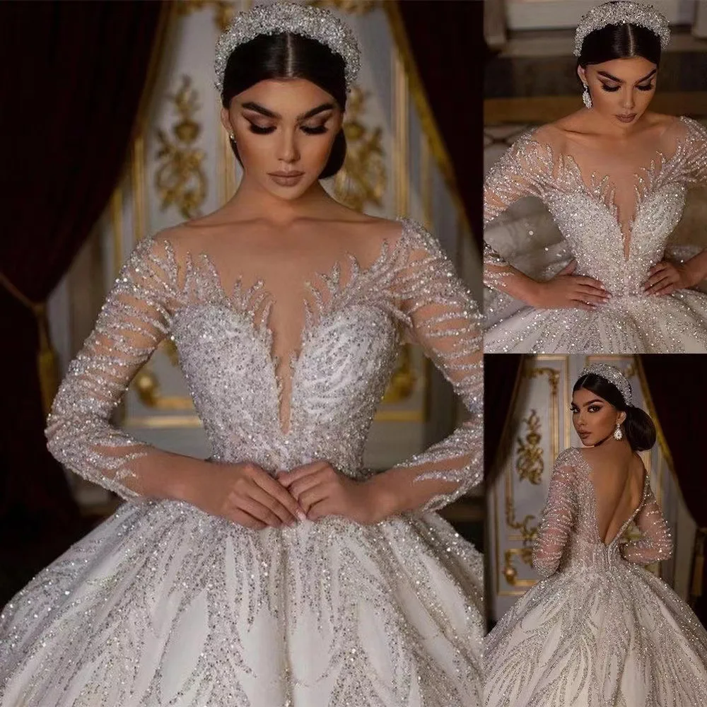

Sparkling Elegance A Stunning Long-Sleeved Wedding Dress Crystal Accents Fluffy Bridal Gown
