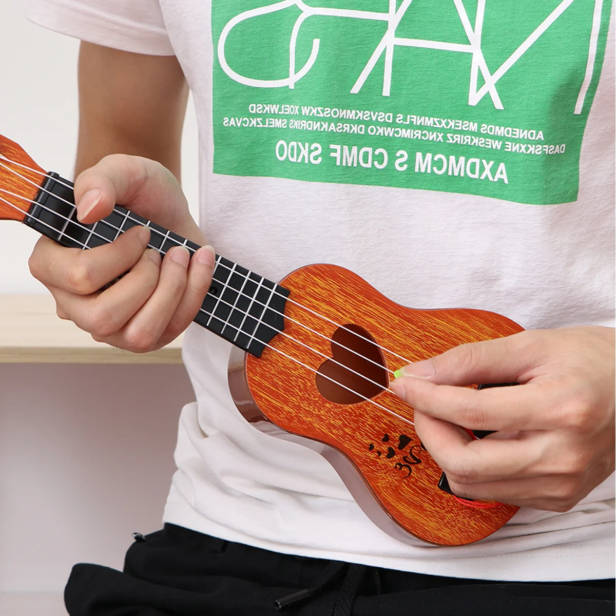 Children Small Size Musical Instruments Imitated Ukulele Mini Guitar Playing Toy with Four Strings
Children Small Size Musical Instruments Imitated Ukulele Mini Guitar Playing Toy with Four Strings