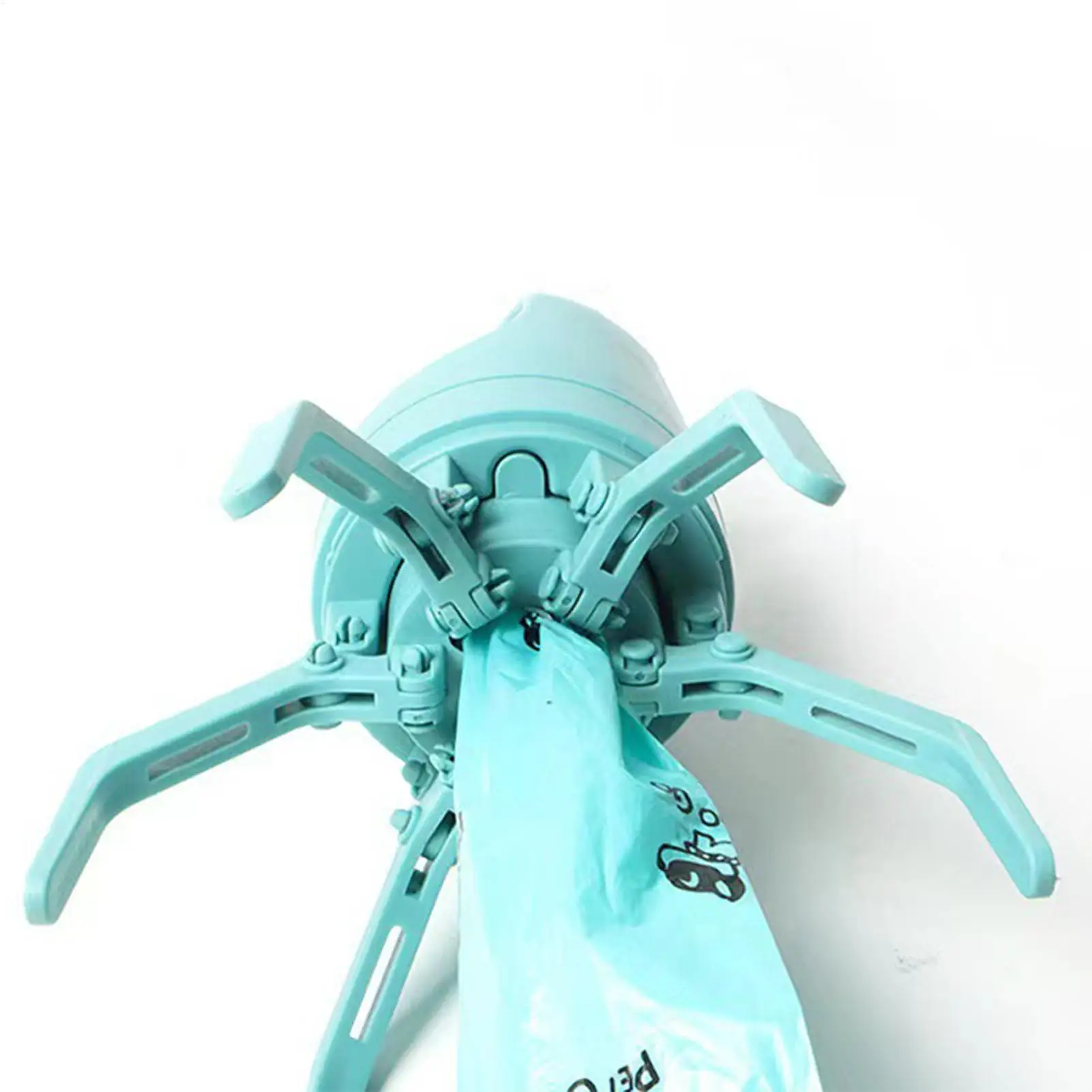 Dog Poop Scooper | Dog Waste Picker An underside view of the scooper showing a light blue plastic bag being pulled through the center hole of the six-claw mechanism.