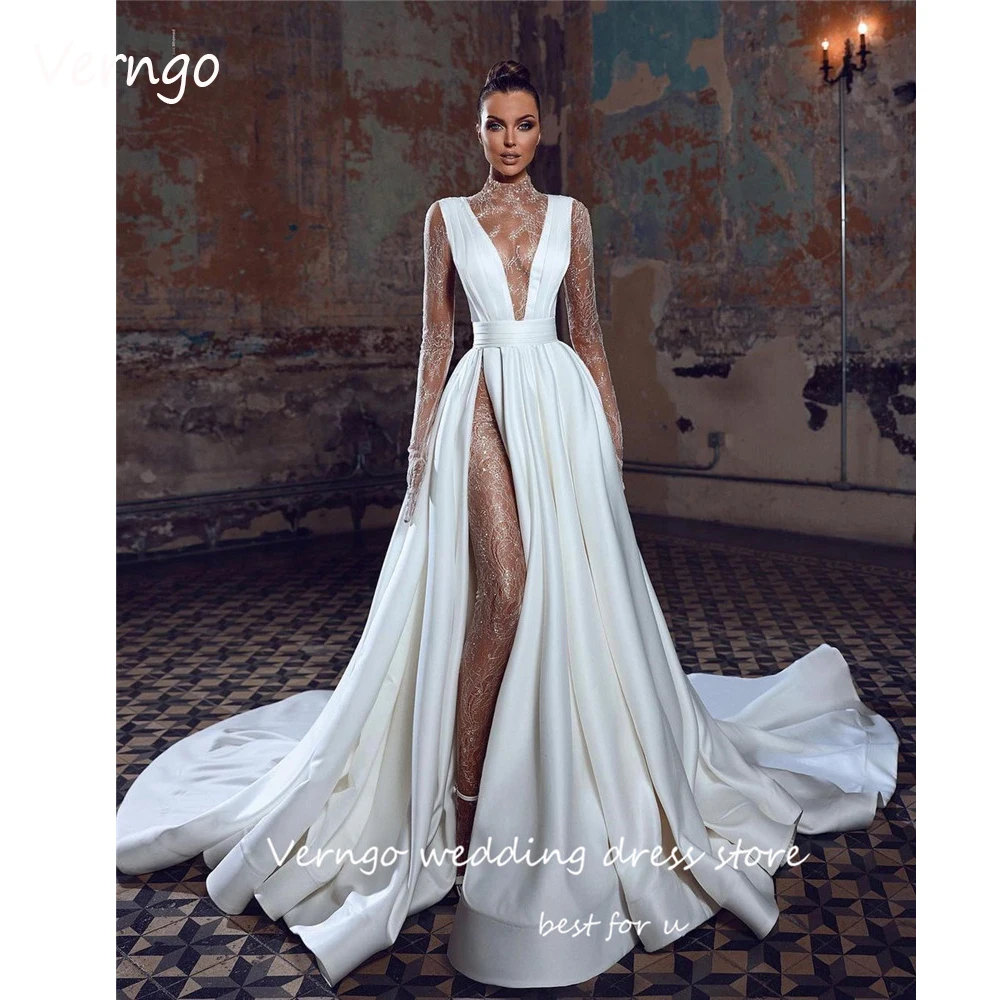 Современные кружевные свадебные платья Verngo с высоким воротником, сексуальные иллюзионные женские свадебные платья с длинным рукавом и высоким разрезом Дубая, свадебное платье
Современные кружевные свадебные платья Verngo с высоким воротником, сексуальные иллюзионные женские свадебные платья с длинным рукавом и высоким разрезом Дубая, свадебное платье