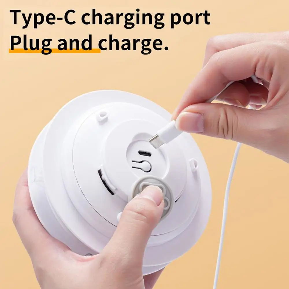 Indoor Cat Toy | Star-Shaped Automatic Cat Toys Close-up of a person’s hands plugging a white USB Type-C charging cable into the bottom of the toy’s power hub. Text reads "Type-C charging port, Plug and charge."