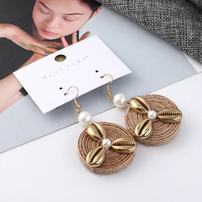 Renya Metal Shell Imitation Pearl Charms Earring Brown Round Rattan Knit Drop Earring for Women Girls Statement Earring Jewelry
Renya Metal Shell Imitation Pearl Charms Earring Brown Round Rattan Knit Drop Earring for Women Girls Statement Earring Jewelry