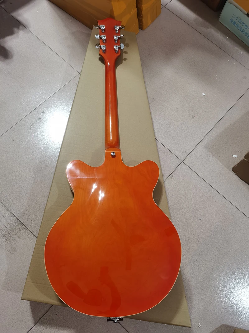 Swiss orange-red electric guitar, white electronic hardware, body semi-hollow, double F-holes, in stock, high-grade bridge 
Swiss orange-red electric guitar, white electronic hardware, body semi-hollow, double F-holes, in stock, high-grade bridge