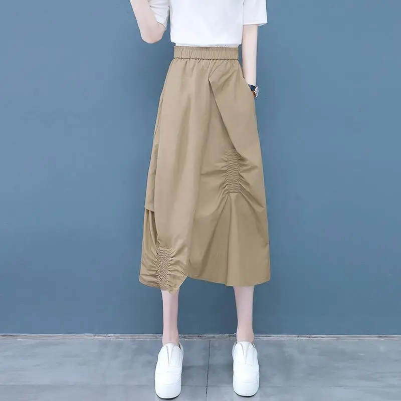 

Fashion Elastic Spliced Folds Asymmetrical Skirts Women's Clothing 2024 Summer New Loose Solid Color Irregular Casual Skirts